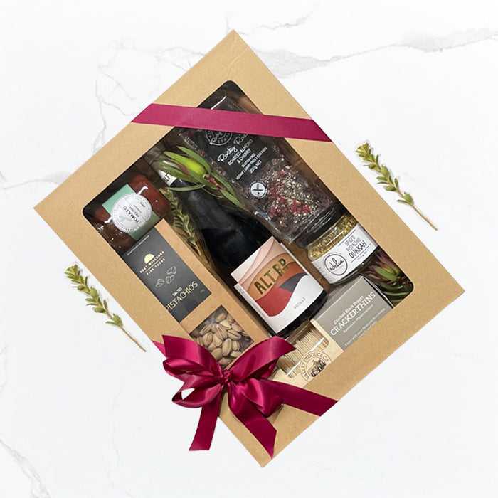 Gluten Free Hamper by Geelong Hampers featuring local Geelong wine, gluten-free crackers, pistachios, tomato relish, almond and cherry rocky road, spiced pistachio dukkah with same-day delivery across Geelong.